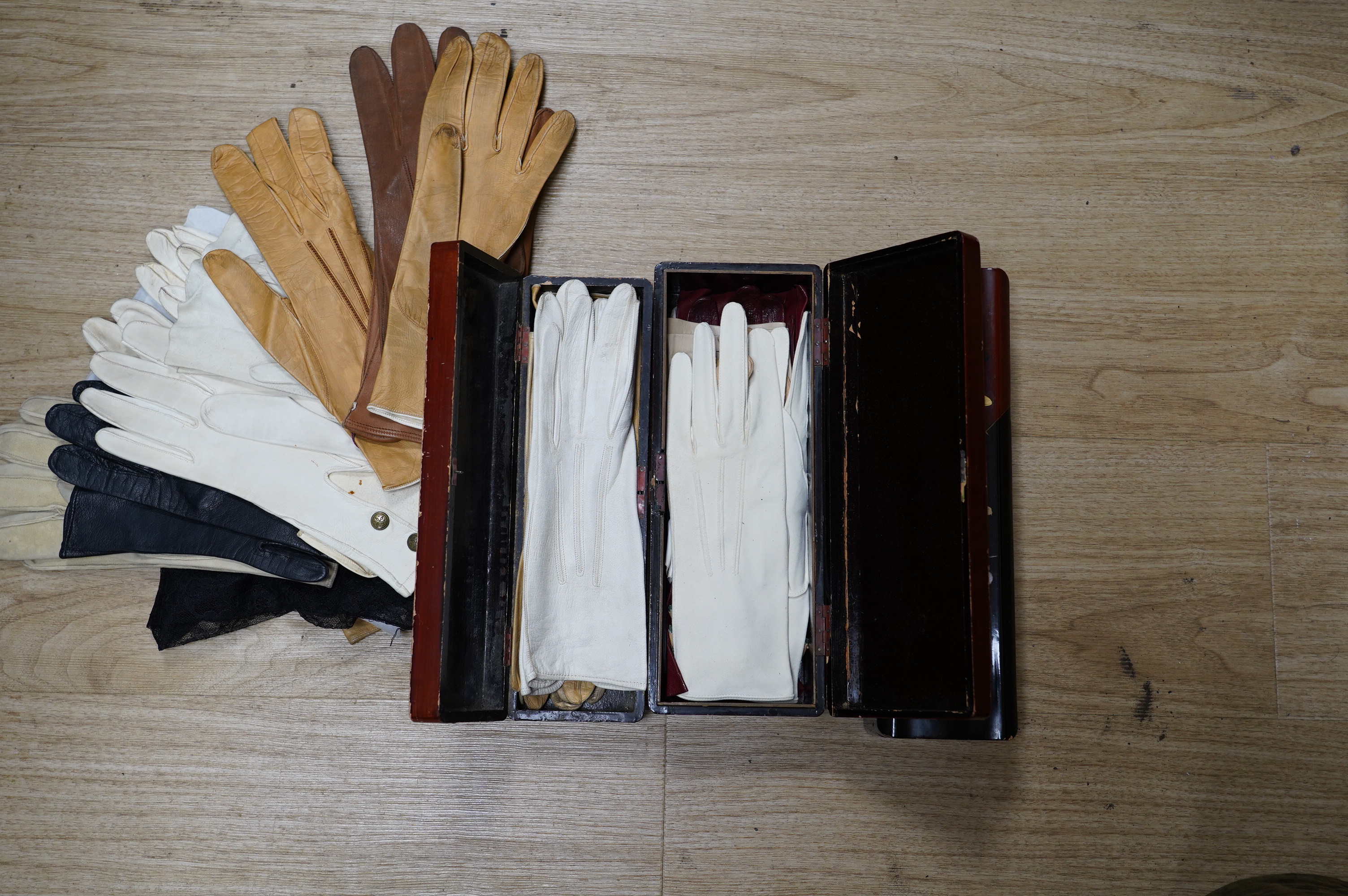 Twenty seven pairs of mostly leather gloves and three lacquered glove boxes, 29cm long. Condition - fair to good